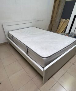 The image shows a white wooden bed frame with a matching headboard and a patterned mattress. - Image 5