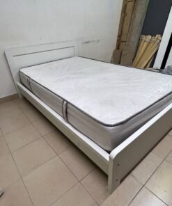 The image shows a white wooden bed frame with a matching headboard and a patterned mattress. - Image 8