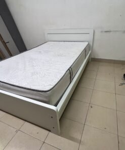 The image shows a white wooden bed frame with a matching headboard and a patterned mattress. - Image 2