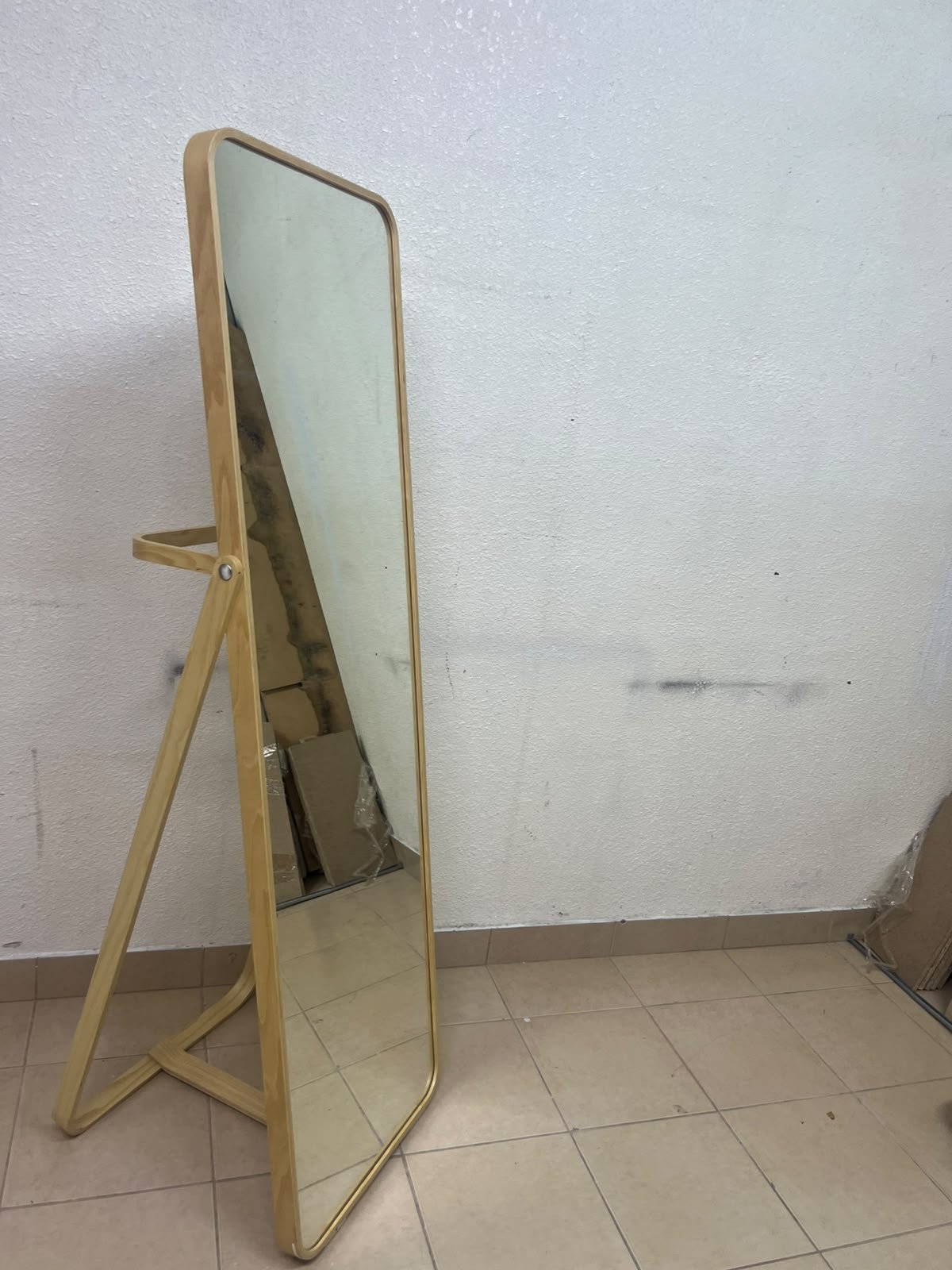 The IKEA IKORNNES ash wood standing mirror, featuring a distinctive rounded wooden frame and a hanging rail integrated into the rear stand. - Image 5