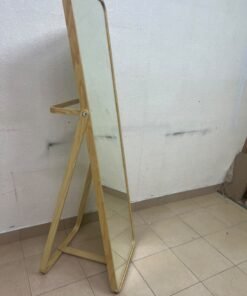 The IKEA IKORNNES ash wood standing mirror, featuring a distinctive rounded wooden frame and a hanging rail integrated into the rear stand. - Image 6