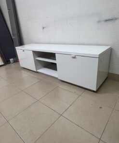 The IKEA BYÅS TV unit in high-gloss white features a sleek, modern design with two cabinets and open central shelves. - Image 2