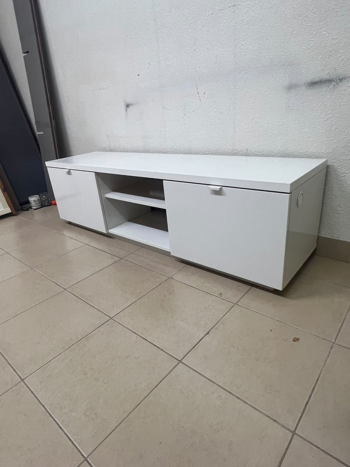 The IKEA BYÅS TV unit in high-gloss white features a sleek, modern design with two cabinets and open central shelves. - Image 2