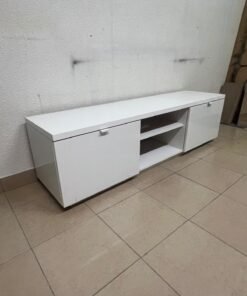 The IKEA BYÅS TV unit in high-gloss white features a sleek, modern design with two cabinets and open central shelves.