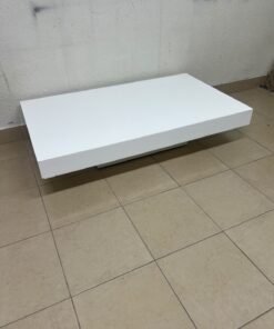 A modern, low, rectangular white coffee table featuring a minimalist design, a recessed base, and a smooth lacquered finish. - Image 2