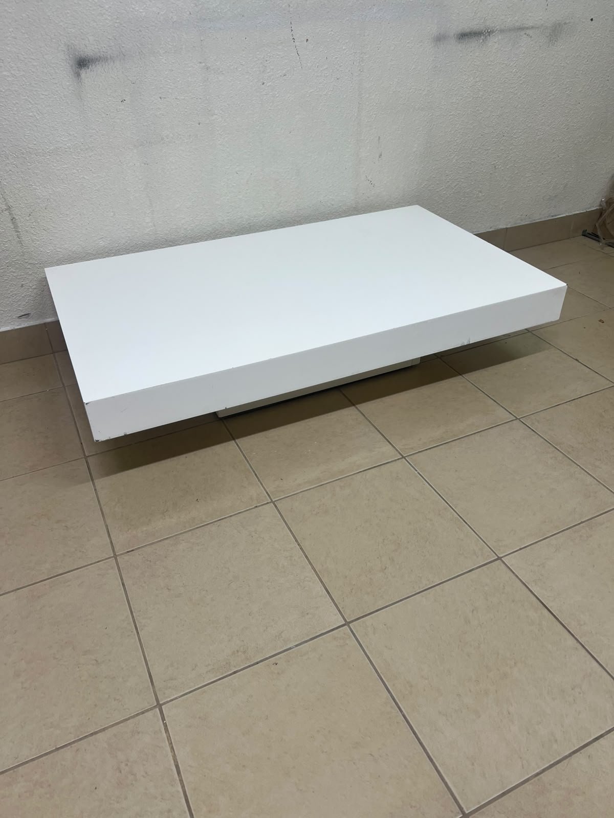 A modern, low, rectangular white coffee table featuring a minimalist design, a recessed base, and a smooth lacquered finish. - Image 2