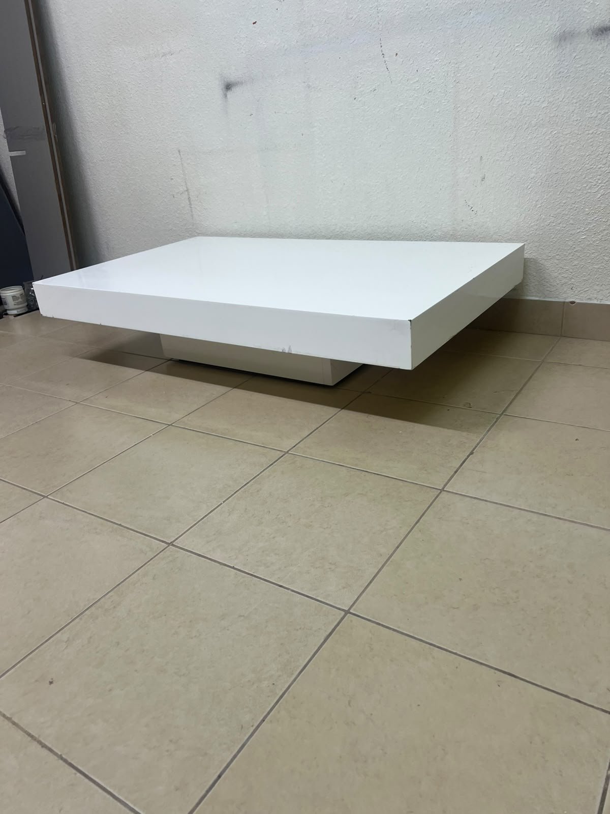 A modern, low, rectangular white coffee table featuring a minimalist design, a recessed base, and a smooth lacquered finish. - Image 3