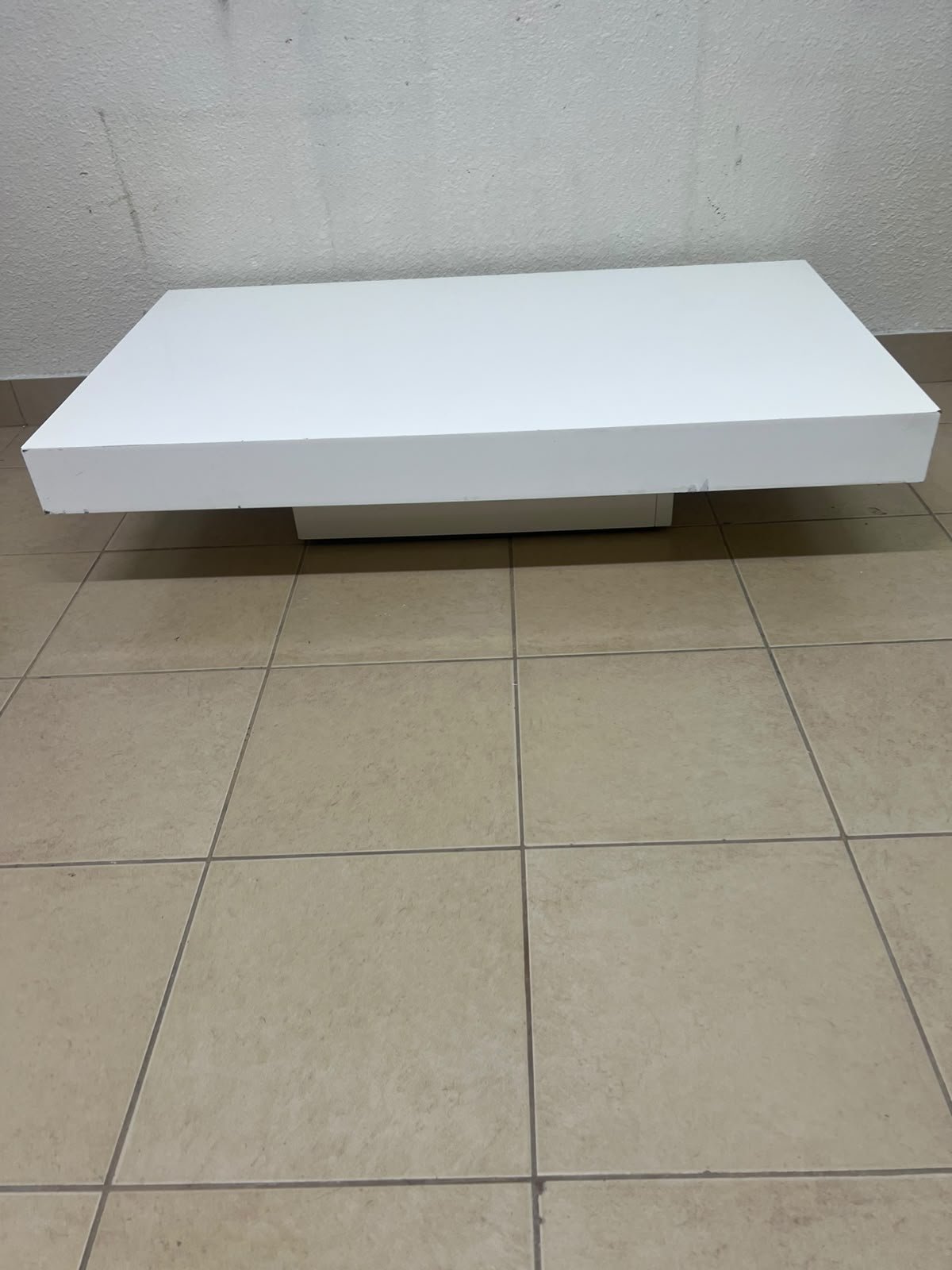 A modern, low, rectangular white coffee table featuring a minimalist design, a recessed base, and a smooth lacquered finish. - Image 5