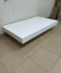 A modern, low, rectangular white coffee table featuring a minimalist design, a recessed base, and a smooth lacquered finish. - Image 6