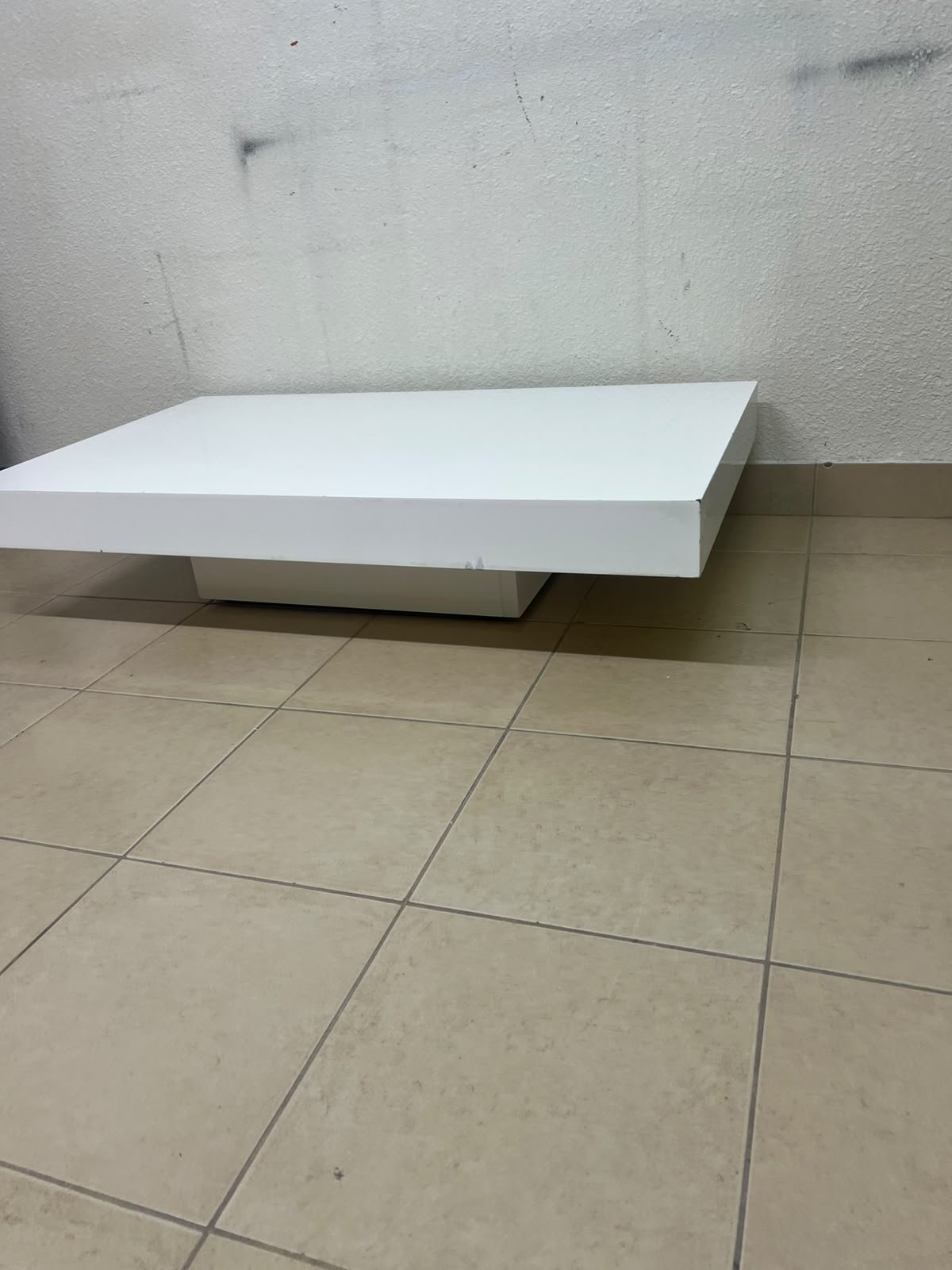 A modern, low, rectangular white coffee table featuring a minimalist design, a recessed base, and a smooth lacquered finish. - Image 7