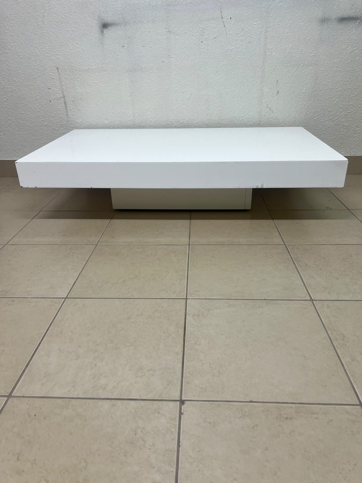 A modern, low, rectangular white coffee table featuring a minimalist design, a recessed base, and a smooth lacquered finish. - Image 9