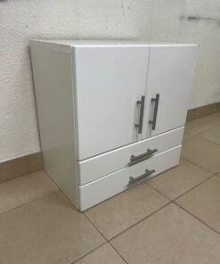 A white wooden storage cabinet featuring two upper doors and two lower drawers equipped with rectangular silver handles. - Image 4