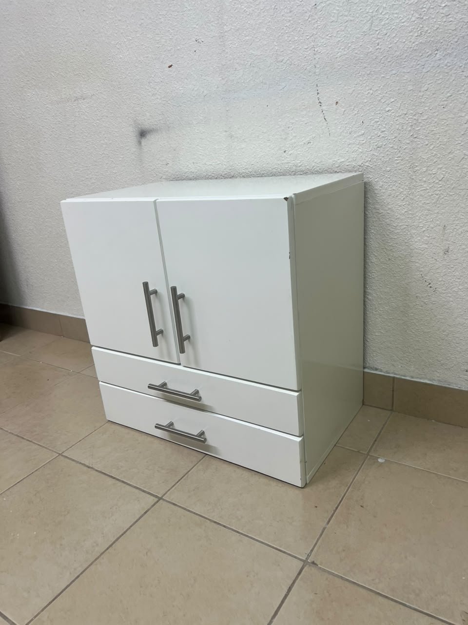 A white wooden storage cabinet featuring two upper doors and two lower drawers equipped with rectangular silver handles. - Image 5