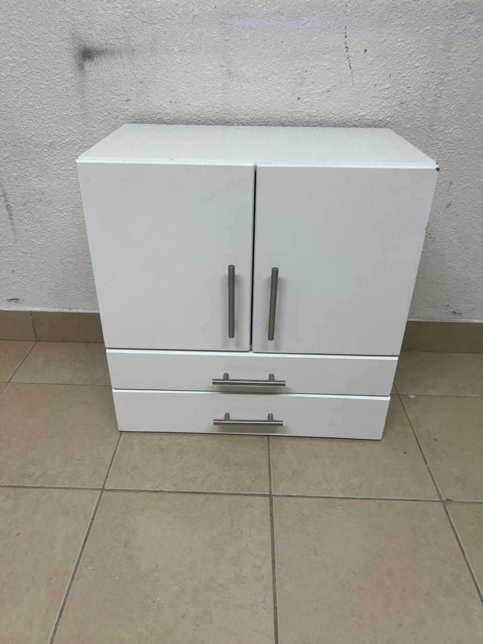 A white wooden storage cabinet featuring two upper doors and two lower drawers equipped with rectangular silver handles. - Image 7