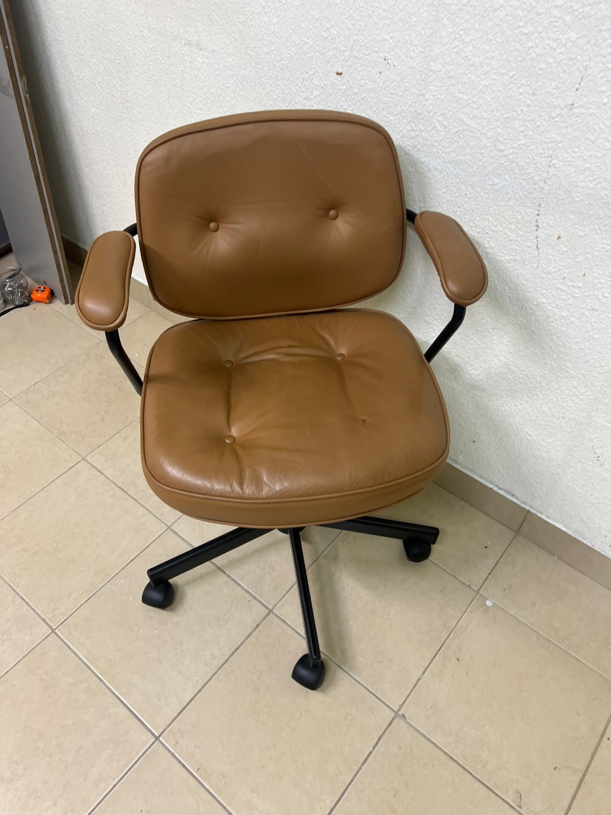 The ALEFJÄLL office chair from IKEA, crafted from golden-brown "Grann" leather and featuring distinctive tufted button detailing.