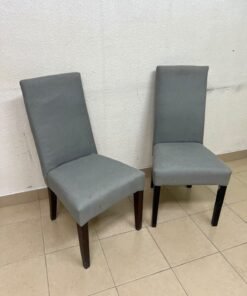 A modern "Parsons" style dining chair, featuring a high back, gray upholstery, and dark wood legs. - Image 2
