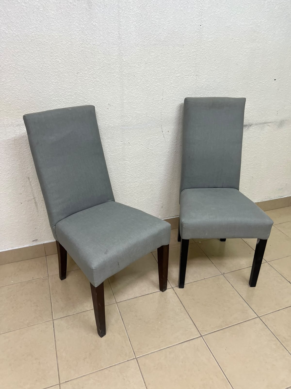 A modern "Parsons" style dining chair, featuring a high back, gray upholstery, and dark wood legs. - Image 2