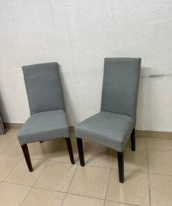 A modern "Parsons" style dining chair, featuring a high back, gray upholstery, and dark wood legs. - Image 4