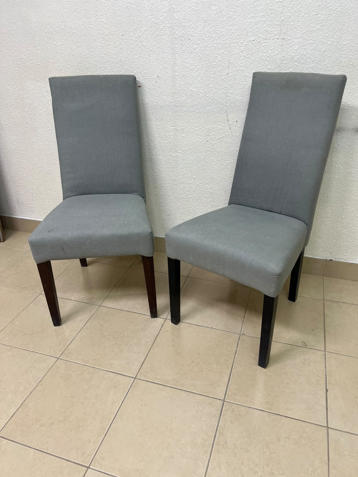 A modern "Parsons" style dining chair, featuring a high back, gray upholstery, and dark wood legs. - Image 5