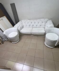 A modern living room furniture set in an off-white or cream hue, featuring a cushioned sofa with a curved back, complemented by matching barrel-style swivel chairs with round bases. - Image 6