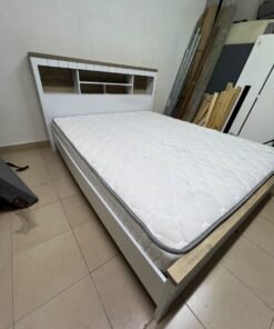 A white wooden King-size bed frame featuring an integrated headboard with shelves, accompanied by a matching padded mattress. - Image 4