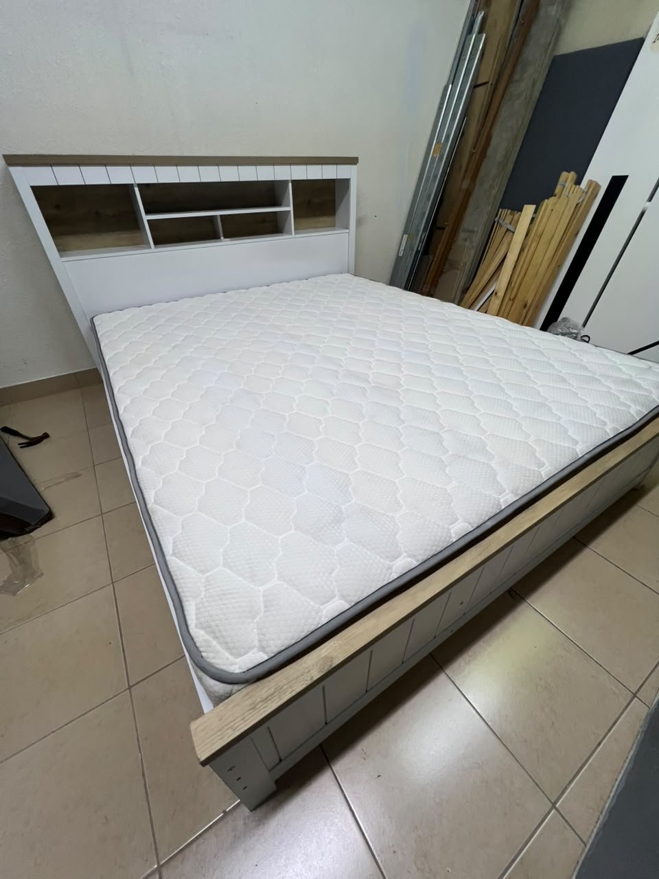 A white wooden King-size bed frame featuring an integrated headboard with shelves, accompanied by a matching padded mattress. - Image 6