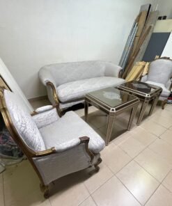 A light-colored, upholstered classic living room set featuring a sofa and armchairs with carved wooden frames, along with two matching mirrored side tables. - Image 8