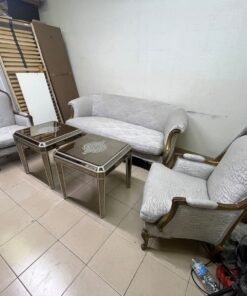 A light-colored, upholstered classic living room set featuring a sofa and armchairs with carved wooden frames, along with two matching mirrored side tables. - Image 10