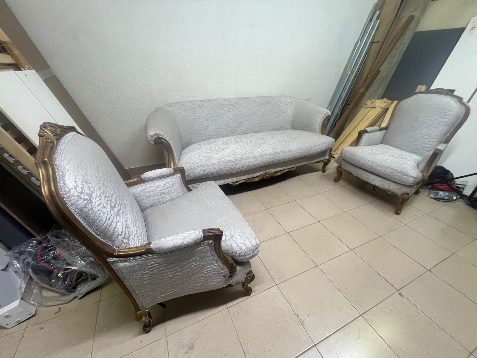 A light-colored, upholstered classic living room set featuring a sofa and armchairs with carved wooden frames, along with two matching mirrored side tables. - Image 11