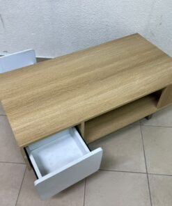 The Adonia coffee table by Danube Home is crafted from oak wood and features a rectangular top with a wood finish, accented by a distinctive white cabinet door. - Image 6