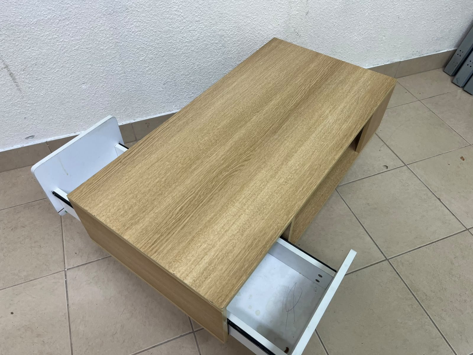 The Adonia coffee table by Danube Home is crafted from oak wood and features a rectangular top with a wood finish, accented by a distinctive white cabinet door. - Image 8