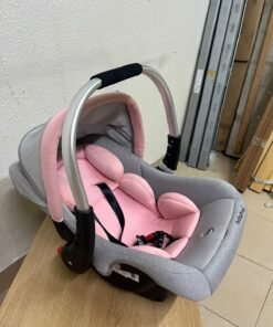 "Babyhug Onyx Elite" car seat and carrycot in grey and pink, featuring an aluminum handle.
