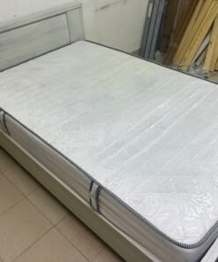 A double bed with a light wood finish, featuring a paneled headboard and a standard upholstered mattress. - Image 2