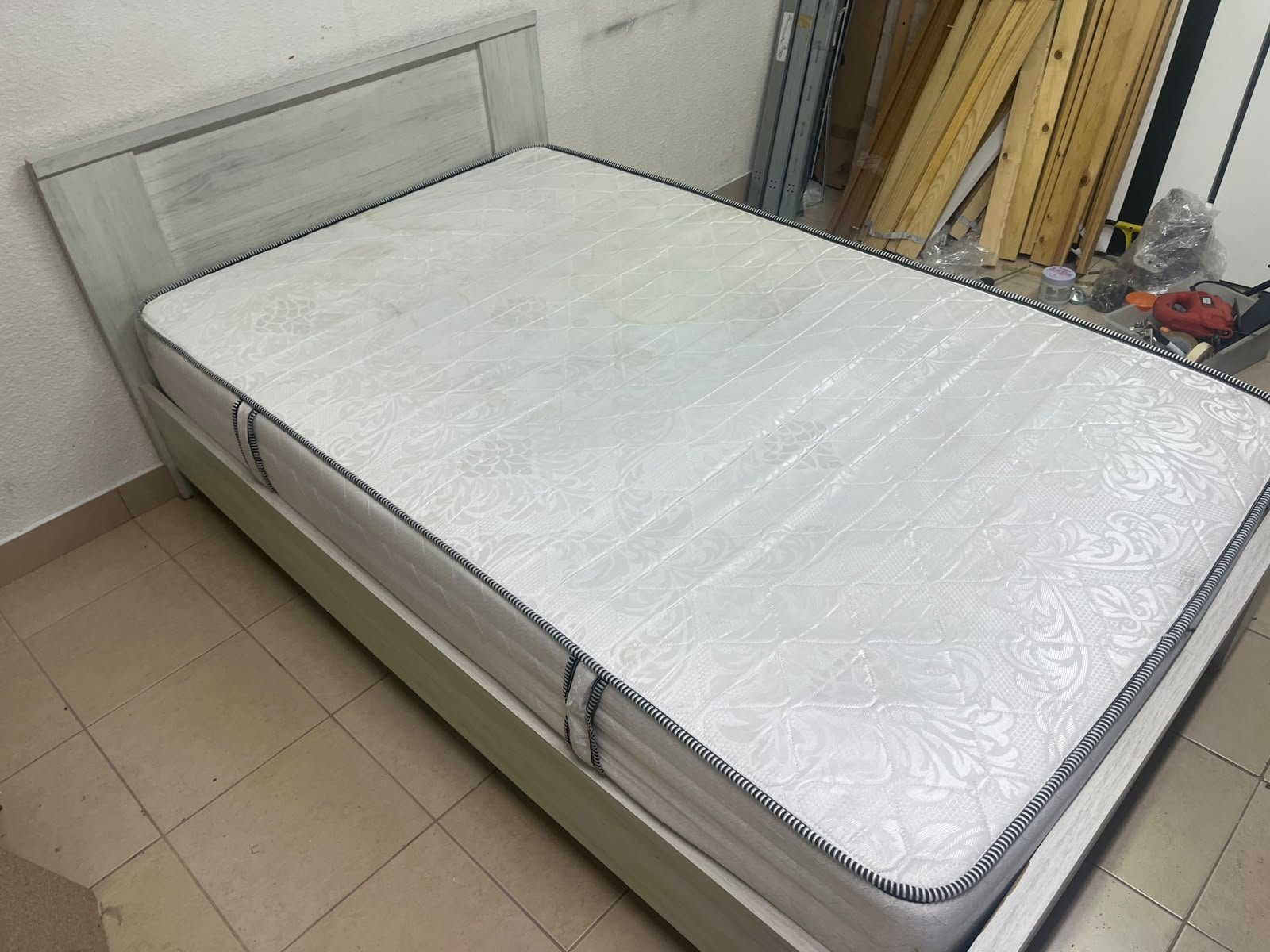 A double bed with a light wood finish, featuring a paneled headboard and a standard upholstered mattress. - Image 2