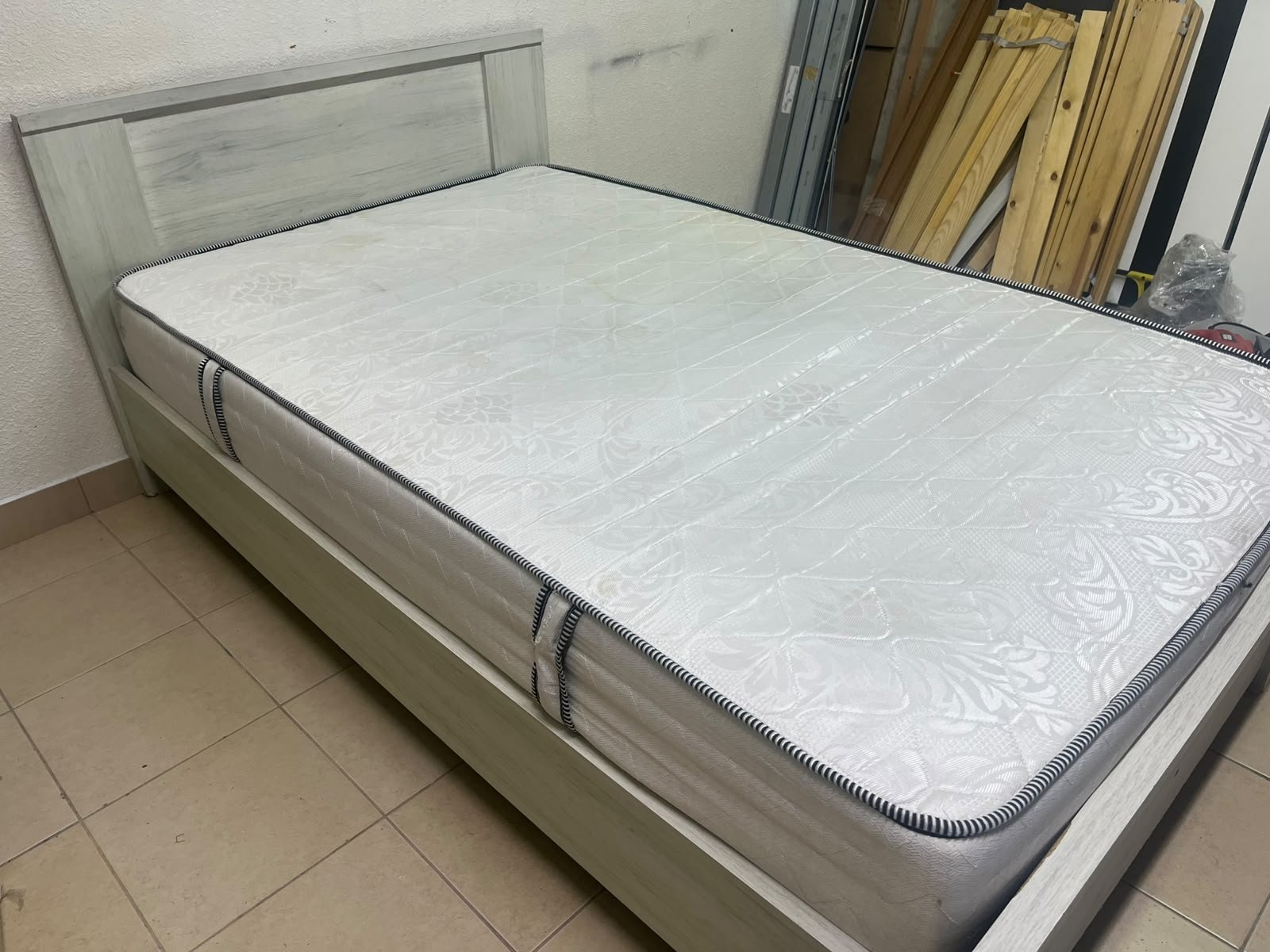 A double bed with a light wood finish, featuring a paneled headboard and a standard upholstered mattress. - Image 4