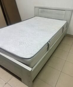 A double bed with a light wood finish, featuring a paneled headboard and a standard upholstered mattress. - Image 5