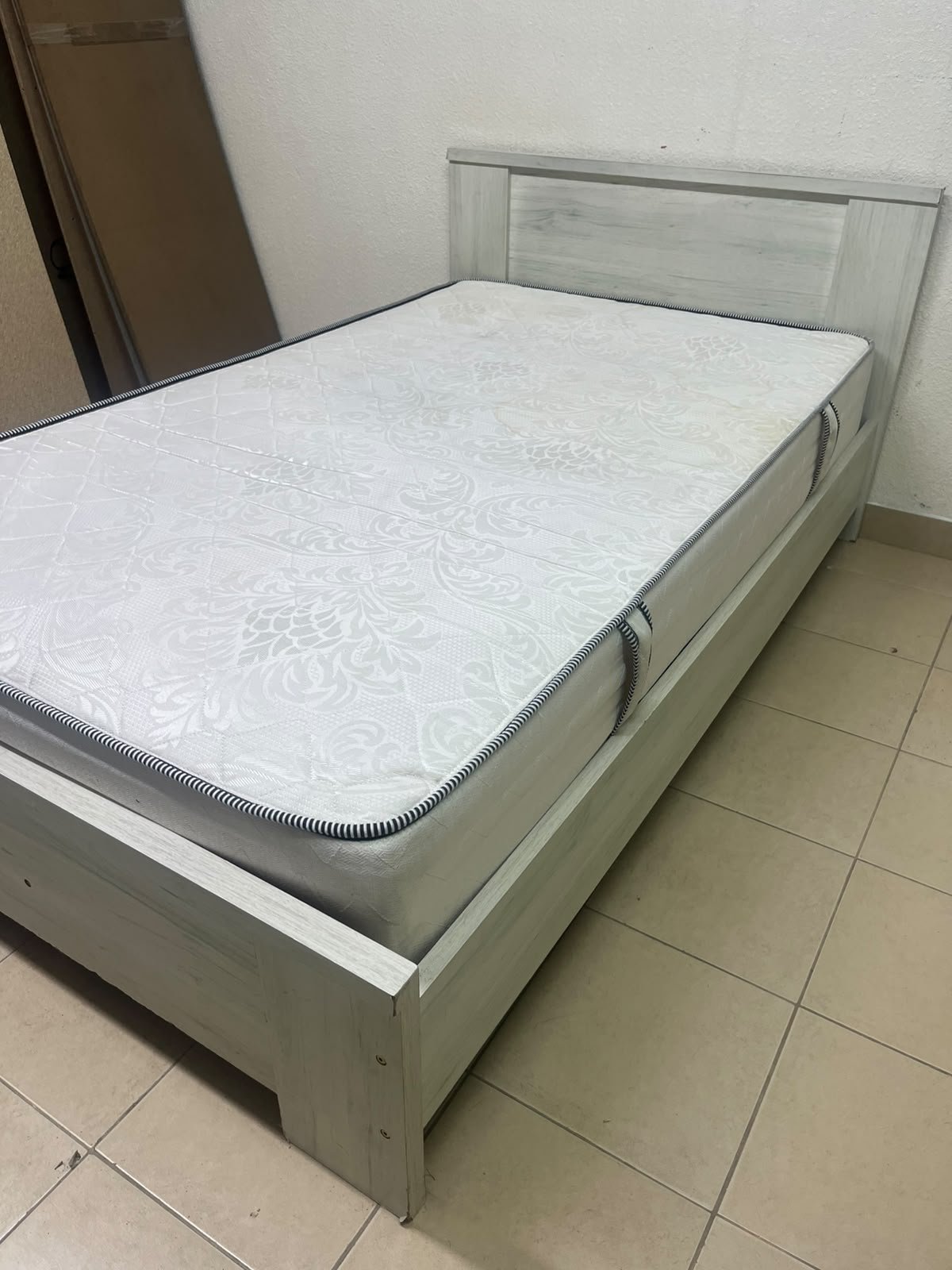 A double bed with a light wood finish, featuring a paneled headboard and a standard upholstered mattress. - Image 5
