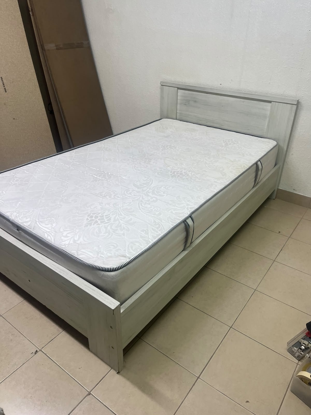 A double bed with a light wood finish, featuring a paneled headboard and a standard upholstered mattress. - Image 6