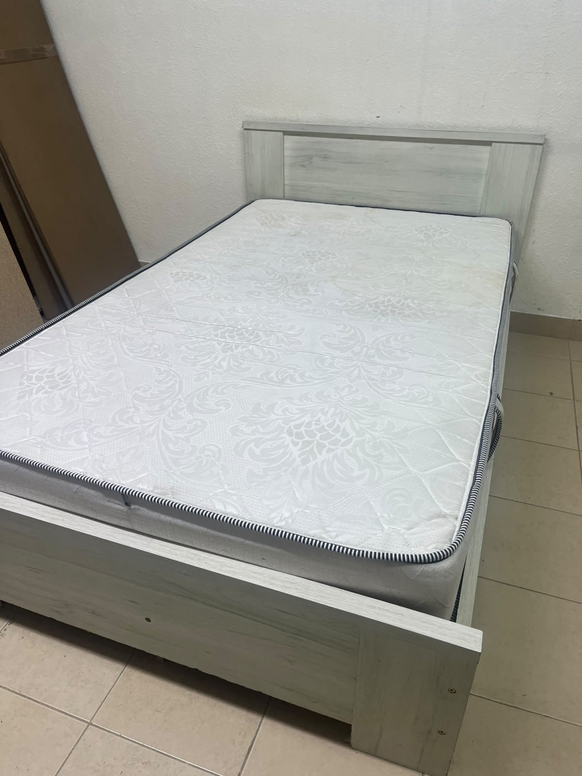 A double bed with a light wood finish, featuring a paneled headboard and a standard upholstered mattress. - Image 8
