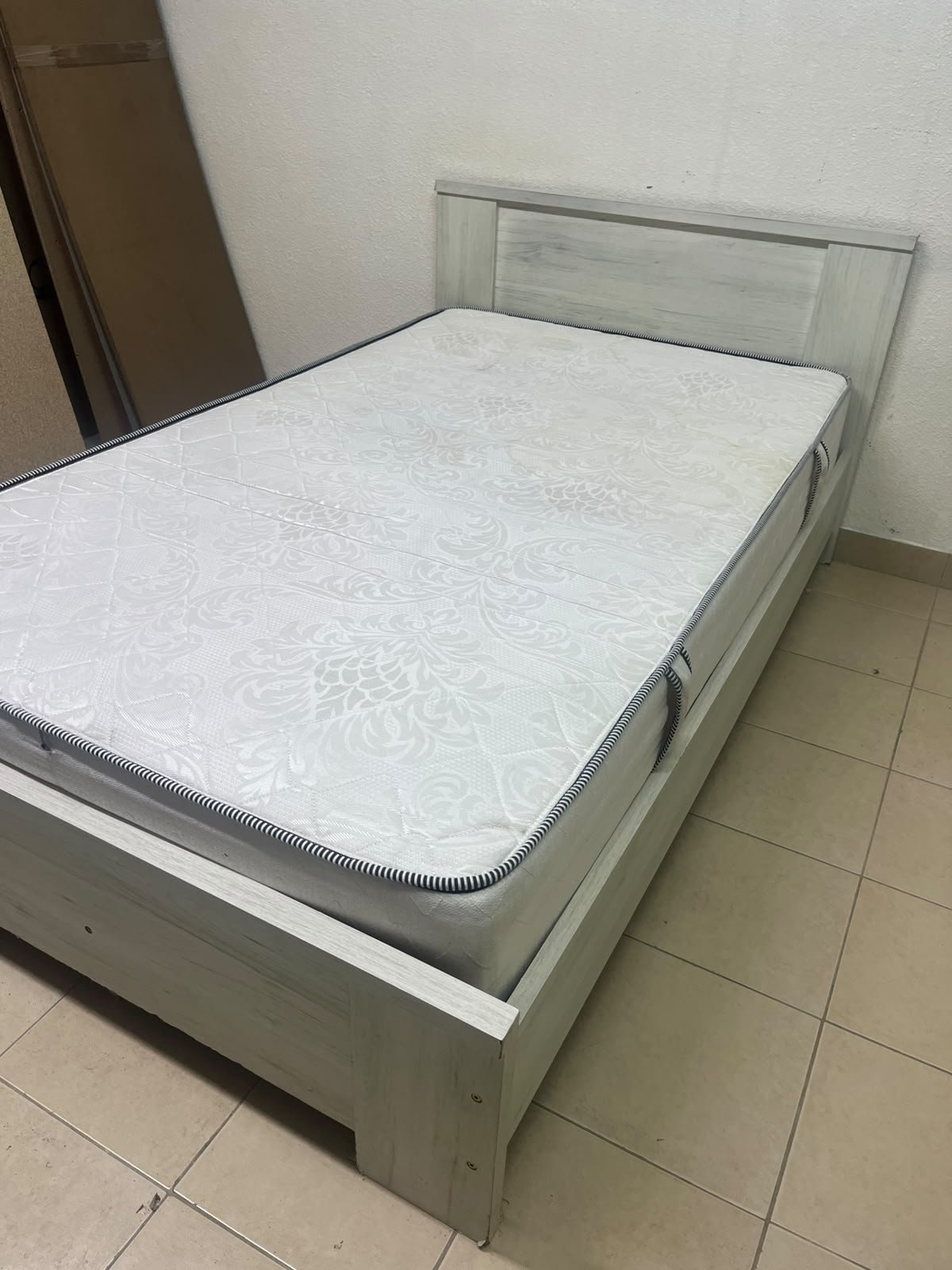 A double bed with a light wood finish, featuring a paneled headboard and a standard upholstered mattress. - Image 10