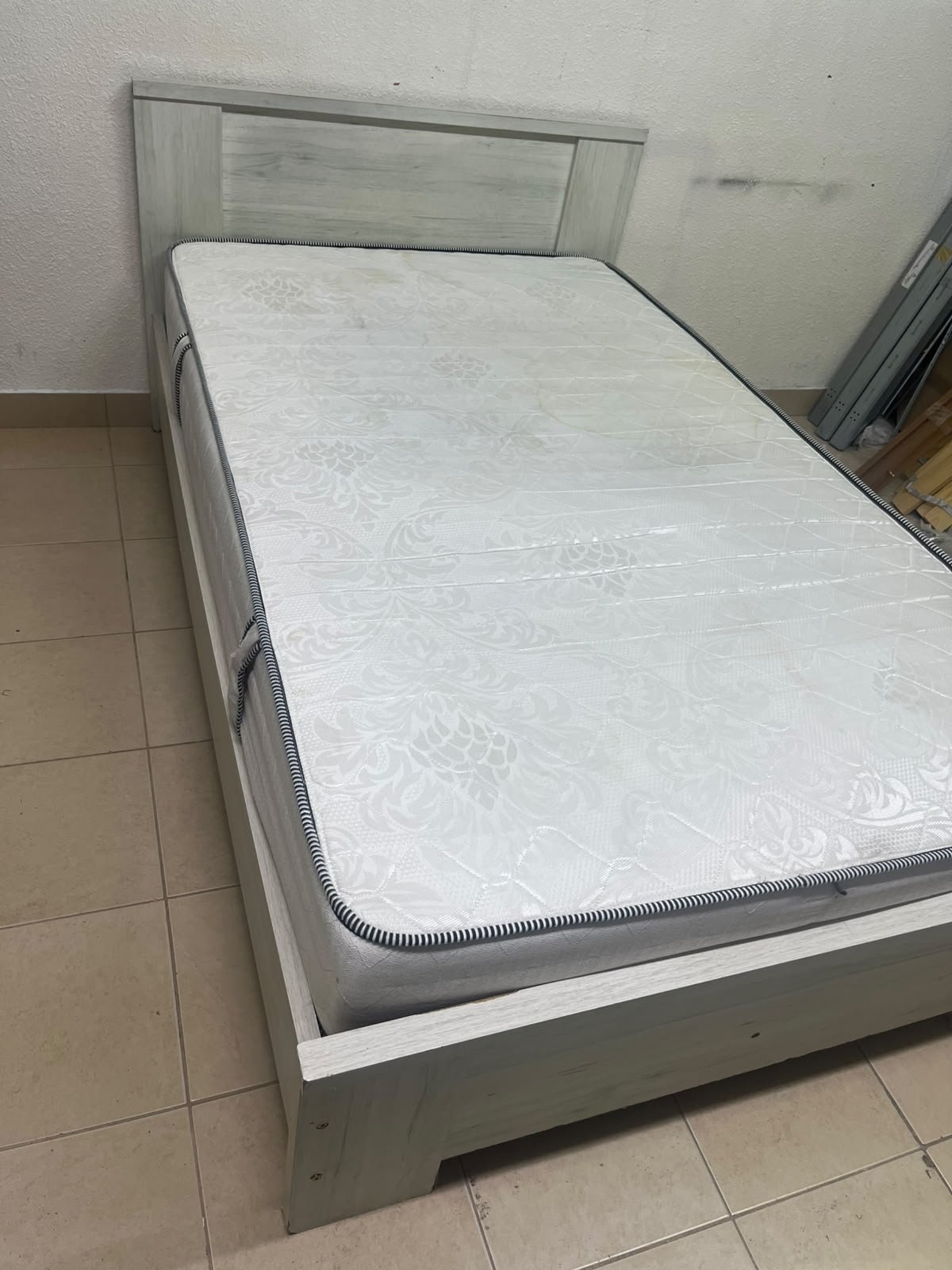 A double bed with a light wood finish, featuring a paneled headboard and a standard upholstered mattress. - Image 11