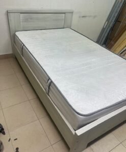 A double bed with a light wood finish, featuring a paneled headboard and a standard upholstered mattress. - Image 3