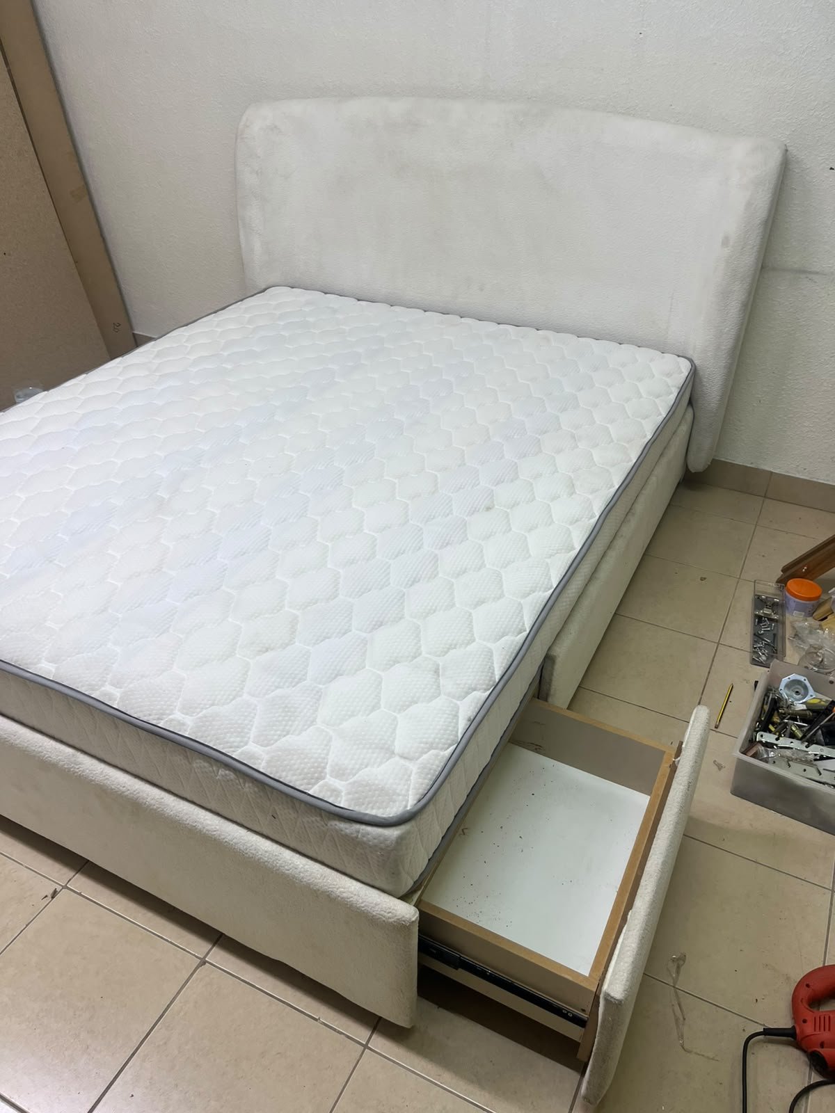 A modern, minimalist beige platform bed featuring a curved, upholstered headboard and a cushioned white mattress. - Image 3