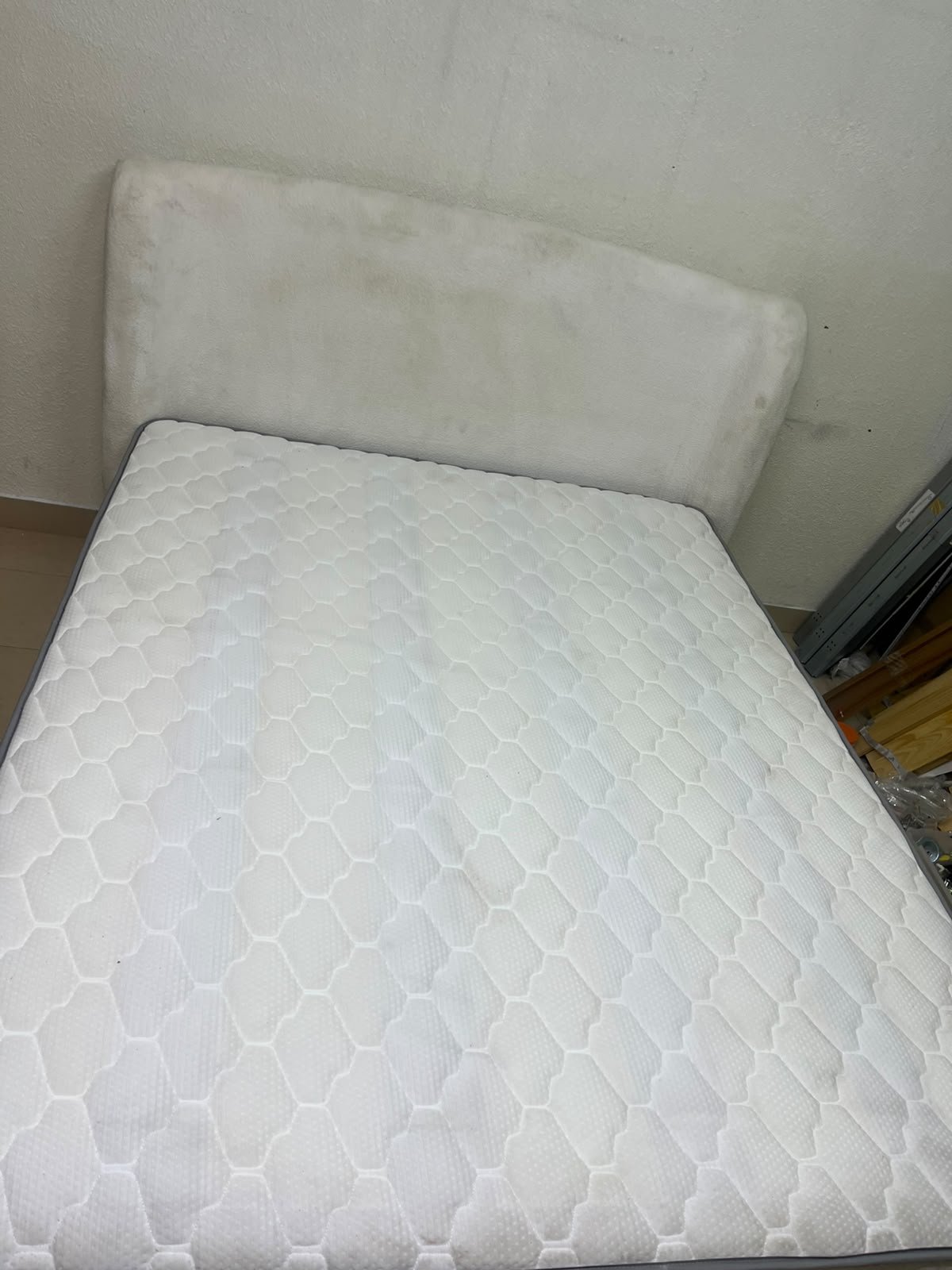 A modern, minimalist beige platform bed featuring a curved, upholstered headboard and a cushioned white mattress. - Image 4