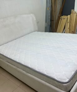 A modern, minimalist beige platform bed featuring a curved, upholstered headboard and a cushioned white mattress. - Image 6