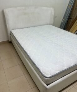 A modern, minimalist beige platform bed featuring a curved, upholstered headboard and a cushioned white mattress. - Image 7