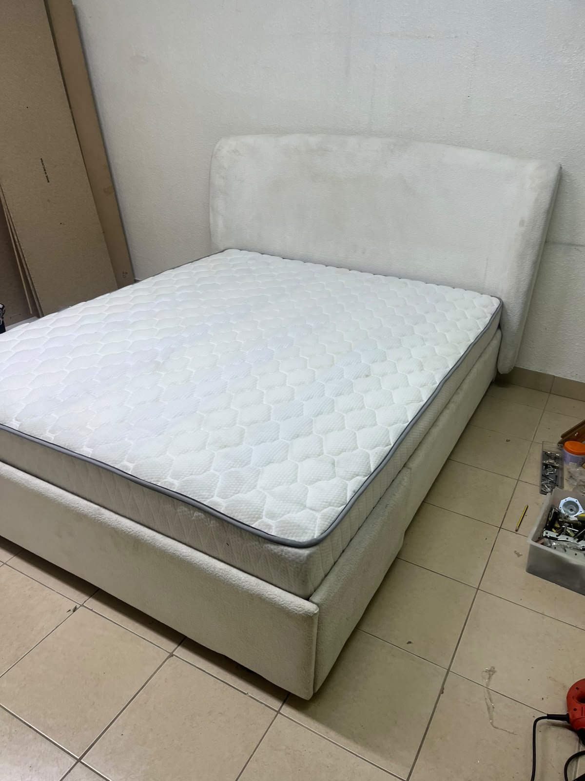 A modern, minimalist beige platform bed featuring a curved, upholstered headboard and a cushioned white mattress. - Image 9