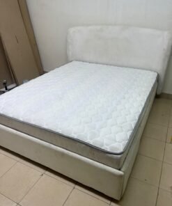 A modern, minimalist beige platform bed featuring a curved, upholstered headboard and a cushioned white mattress. - Image 10