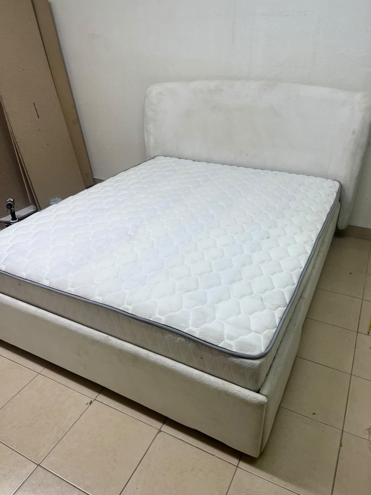 A modern, minimalist beige platform bed featuring a curved, upholstered headboard and a cushioned white mattress. - Image 10