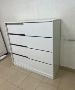 Solis shoe cabinet from Home Centre in white, featuring black horizontal details and sliding doors.